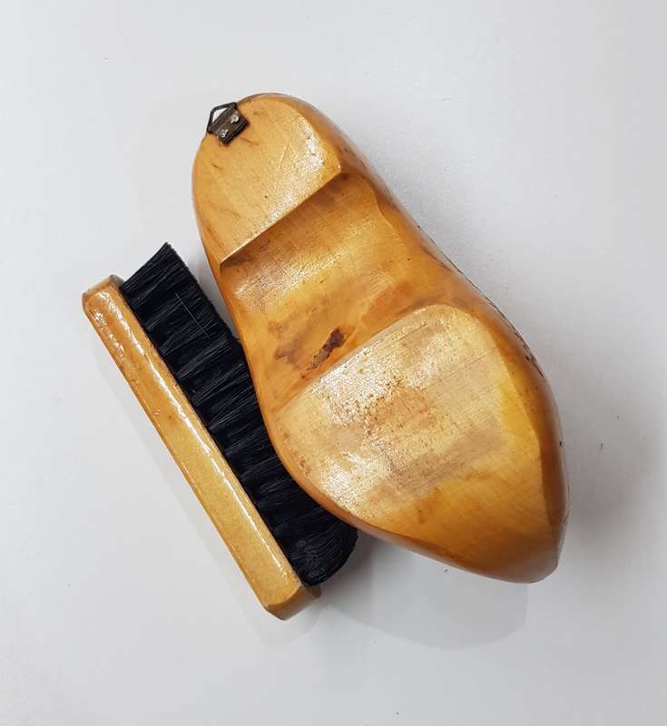 An Antique Handmade ornamental Dutch Wooden Clog with clothes brush wall hanging