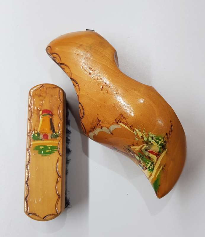 An Antique Handmade ornamental Dutch Wooden Clog with clothes brush wall hanging