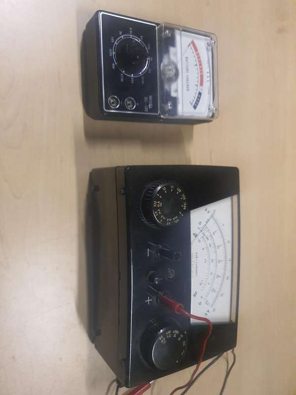 Antique multi-meter and battery tester.