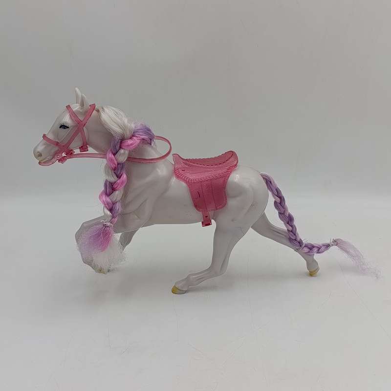 White horse toy with pink saddle