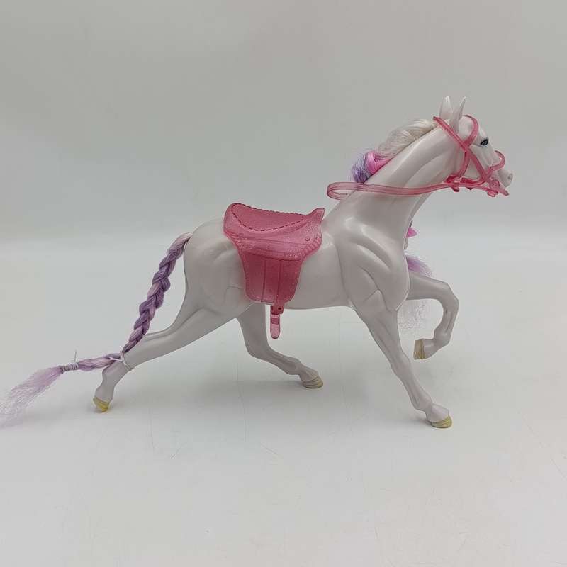 White horse toy with pink saddle