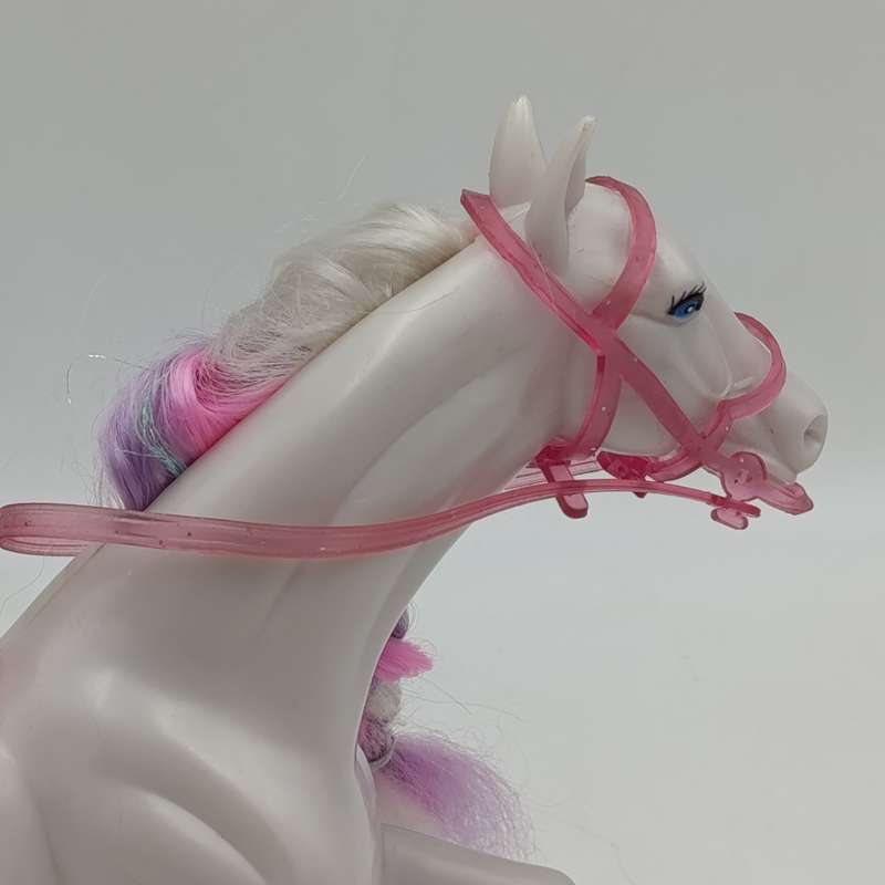 White horse toy with pink saddle