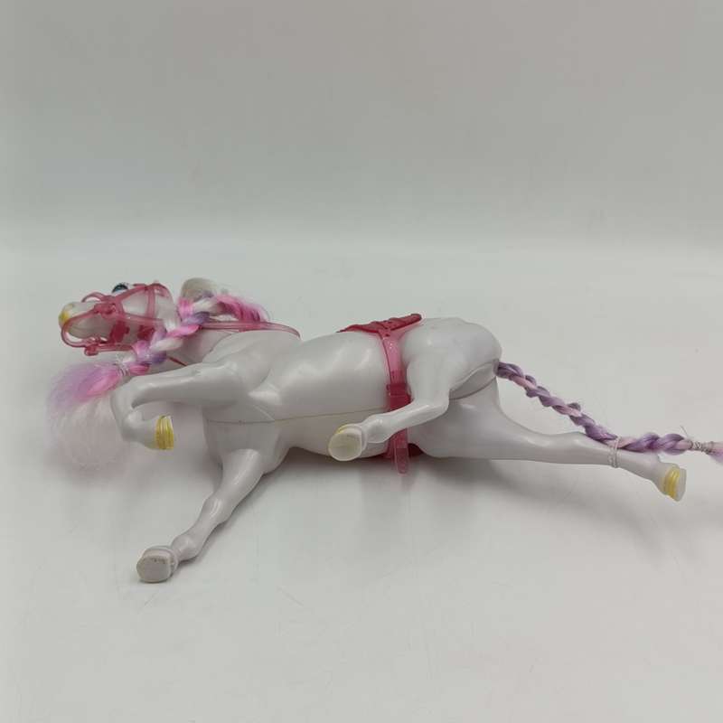 White horse toy with pink saddle