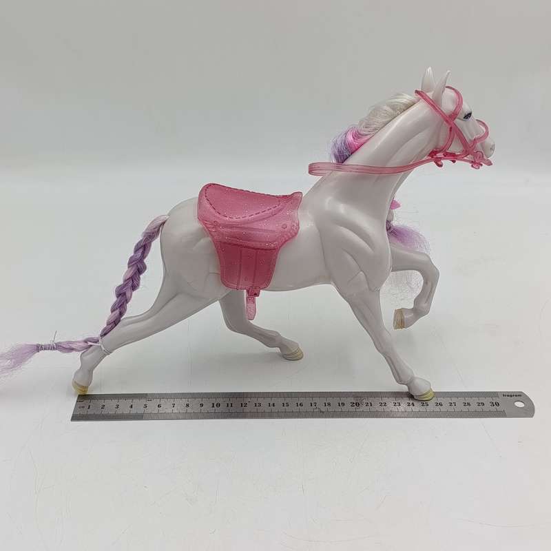 White horse toy with pink saddle