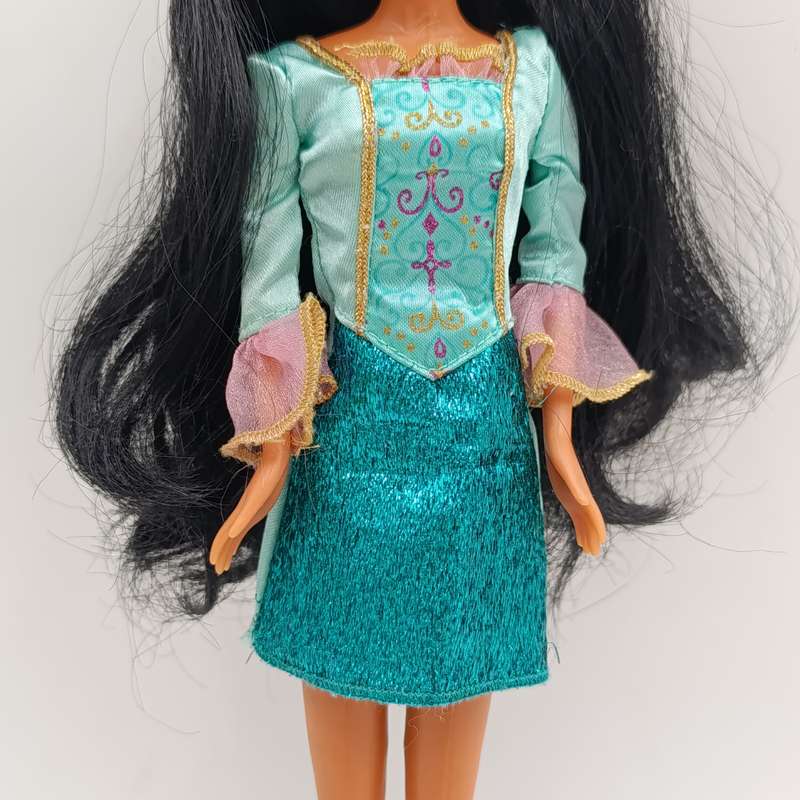 Doll with beautiful black hair and green dress