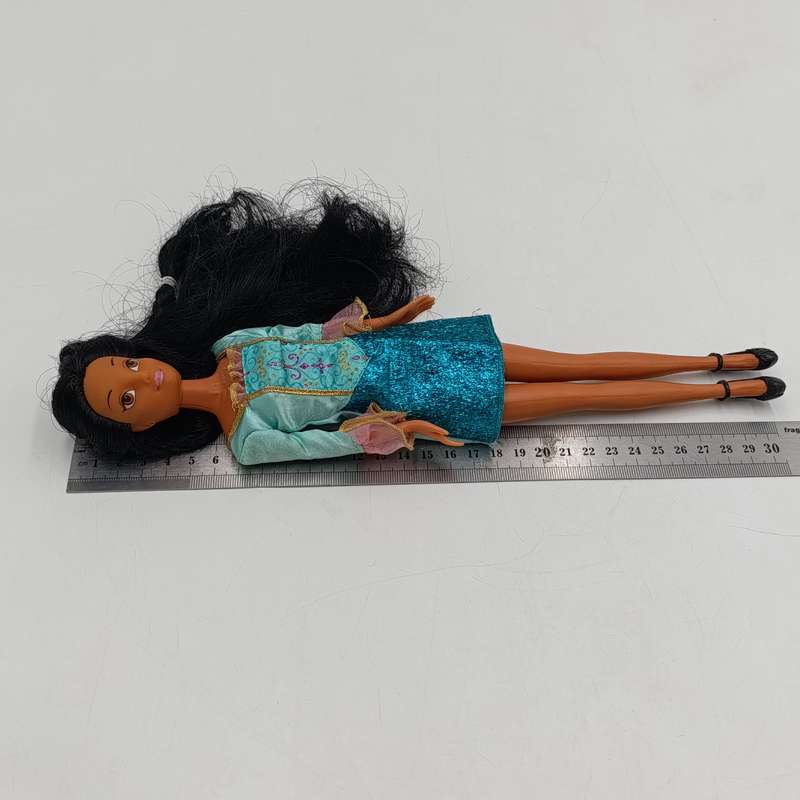 Doll with beautiful black hair and green dress