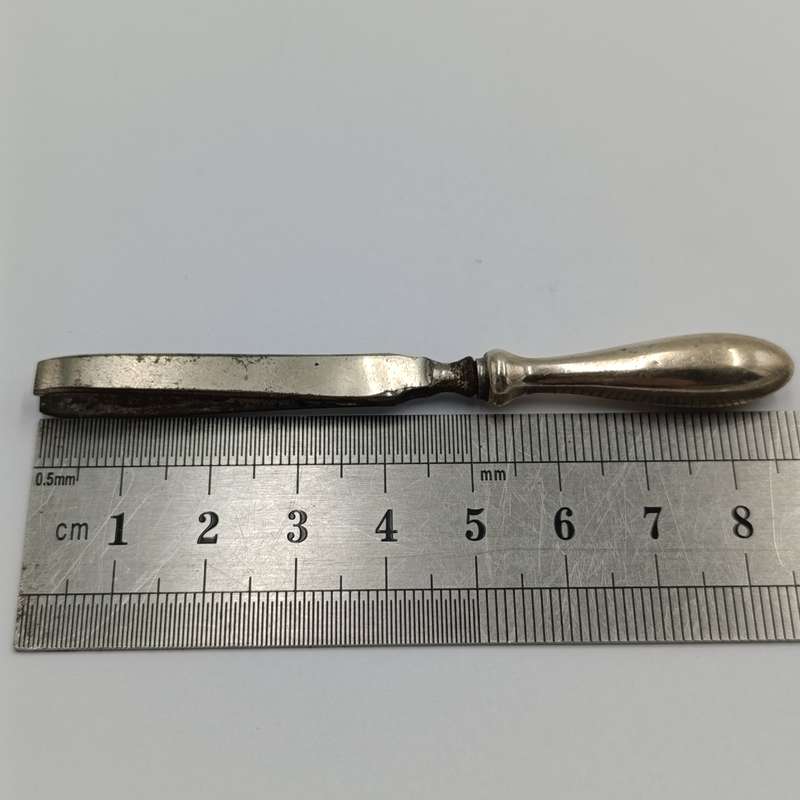 Antique tweezers with hallmarked sterling silver handle