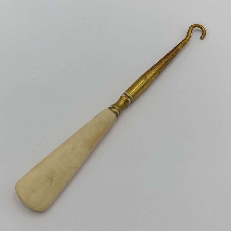Antique brass bootlace puller with bone handle