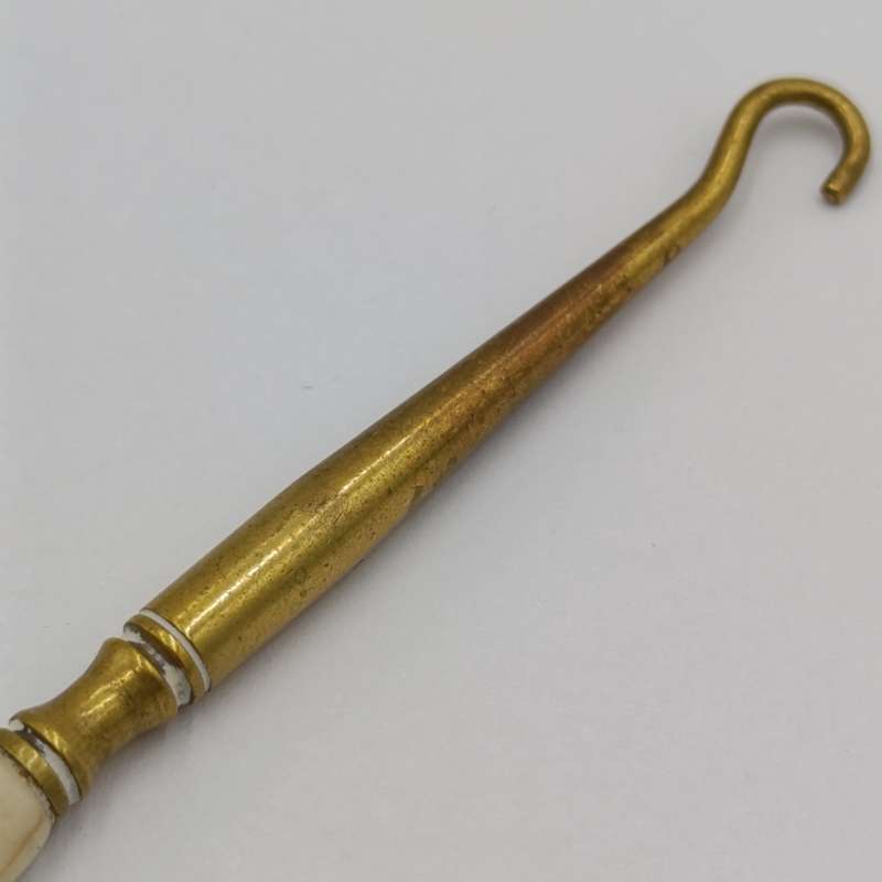 Antique brass bootlace puller with bone handle