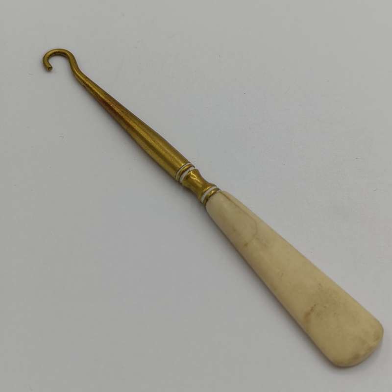 Antique brass bootlace puller with bone handle