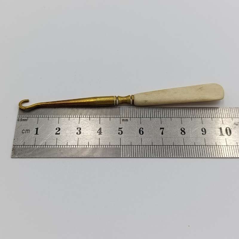 Antique brass bootlace puller with bone handle