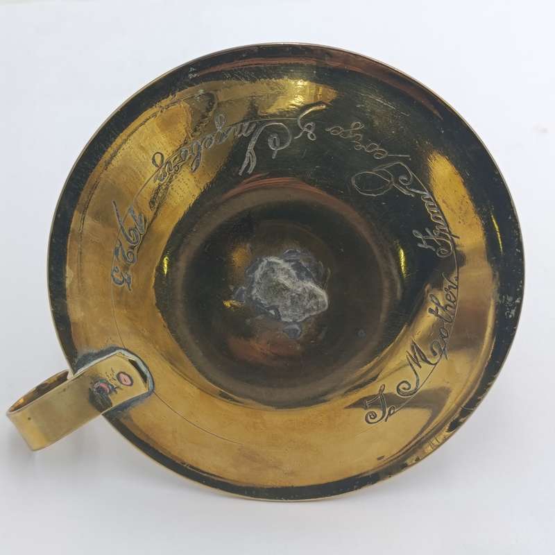 Antique brass candle holder - inscribed at bottom