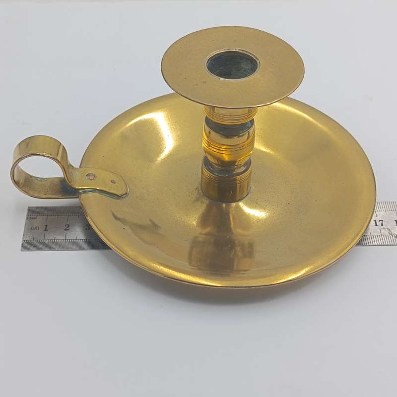 Antique brass candle holder - inscribed at bottom