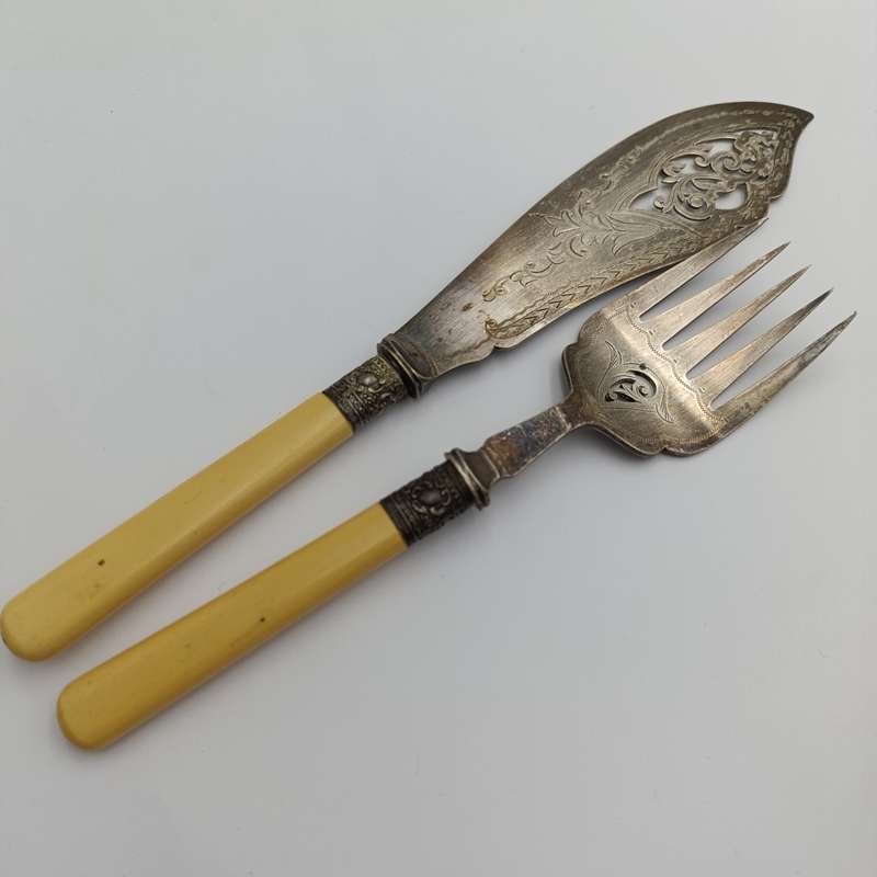 Antique fish serving set with silver trimming with imitation bone handles