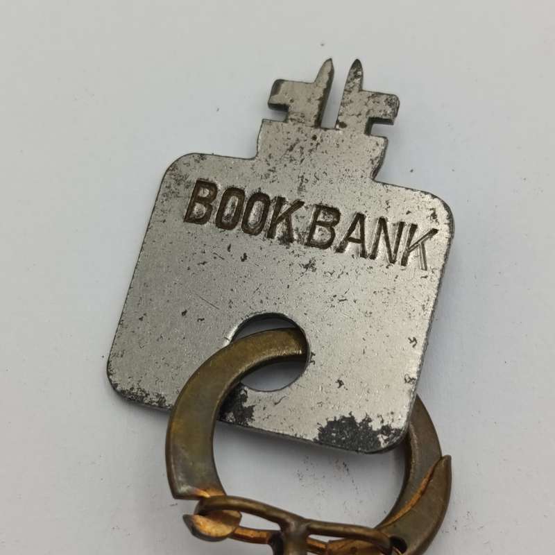 Vintage Nederlandsch-Indie postspaarbank book shaped money box with key