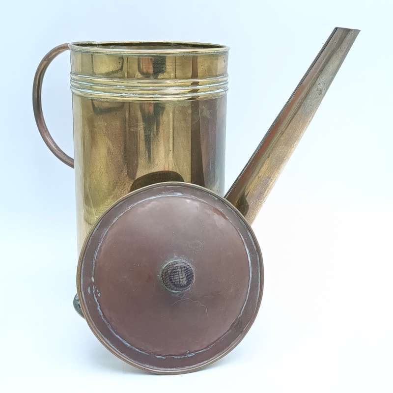 Antique brass watering can