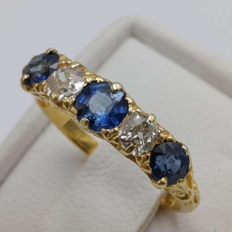 18kt gold ring with 2 diamonds totalling about 40 points and 3 sapphires totalling about 80 points