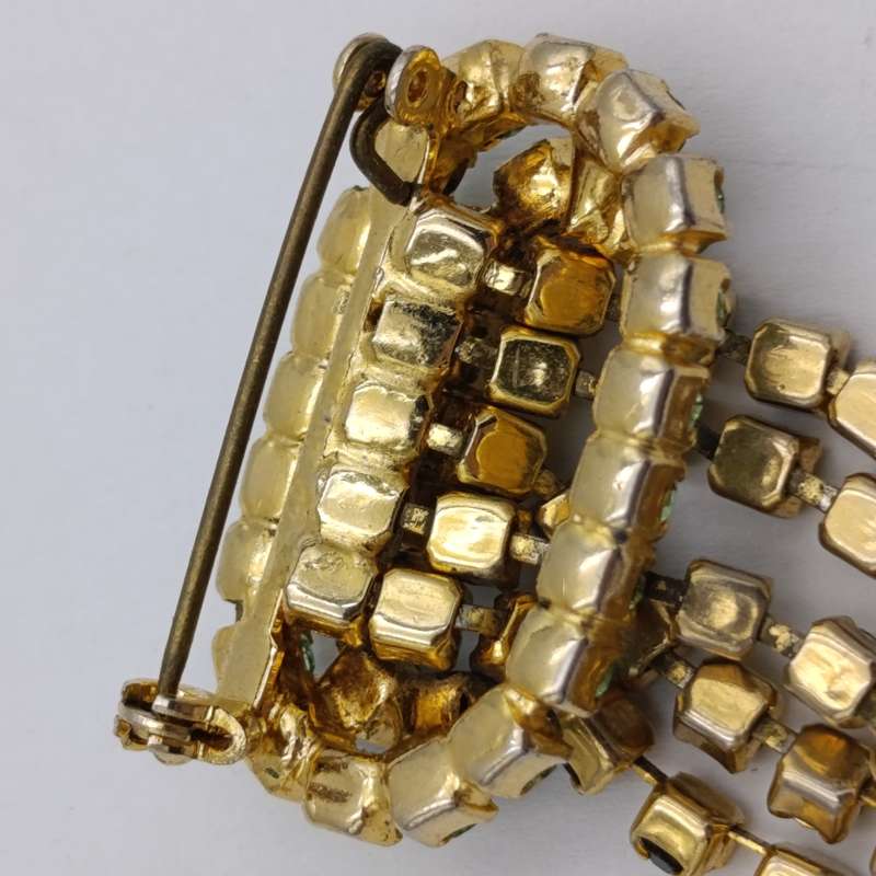 Vintage gold color & green stone brooch
