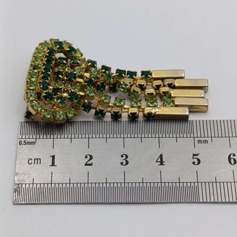 Vintage gold color & green stone brooch