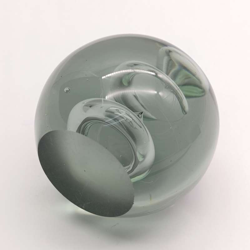Vintage glass paperweight with water drop design inside
