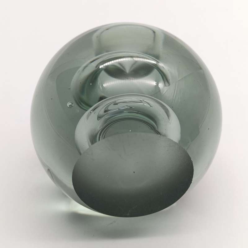 Vintage glass paperweight with water drop design inside