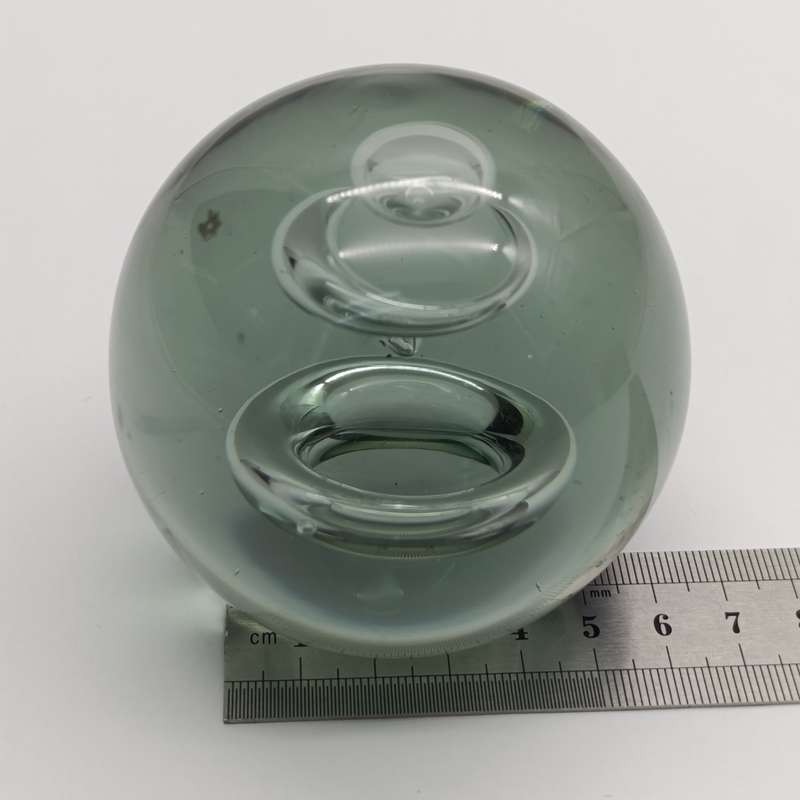 Vintage glass paperweight with water drop design inside