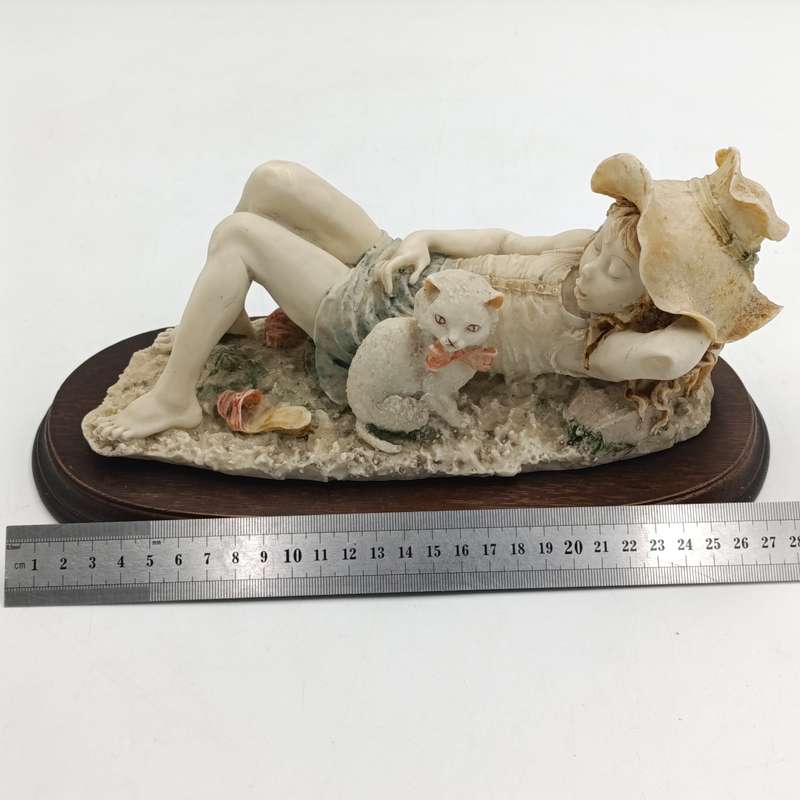 Vintage polyresin sculpture of sleepy girl with cat