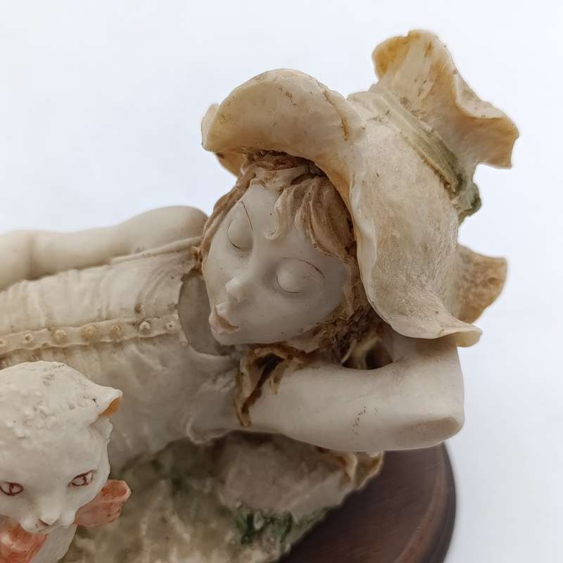 Vintage polyresin sculpture of sleepy girl with cat