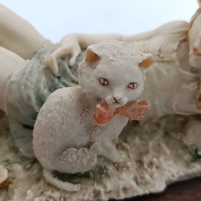 Vintage polyresin sculpture of sleepy girl with cat