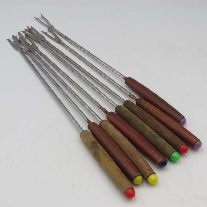 Vintage cast-iron fondue set with 8 forks