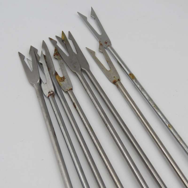 Vintage cast-iron fondue set with 8 forks