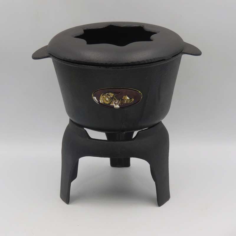 Vintage cast-iron fondue set with 8 forks