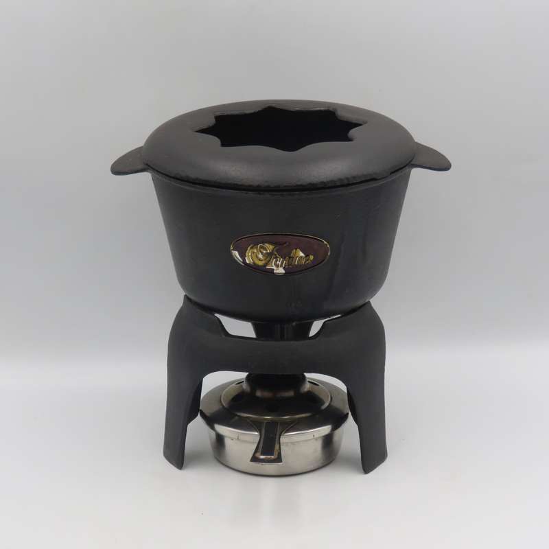 Vintage cast-iron fondue set with 8 forks