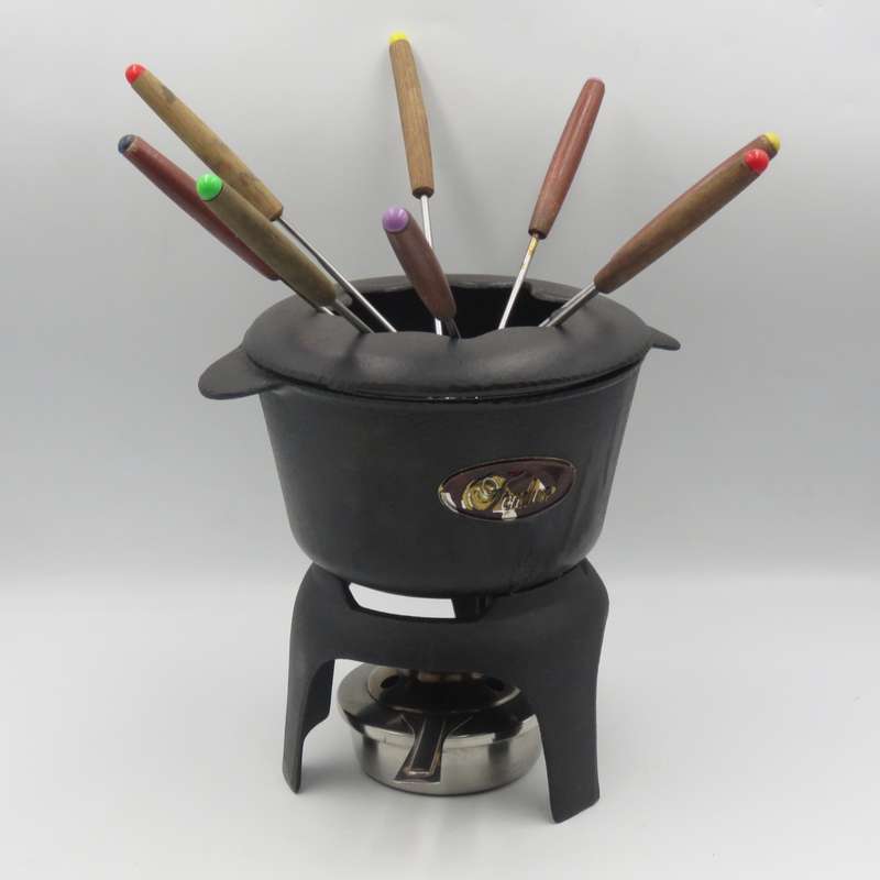 Vintage cast-iron fondue set with 8 forks