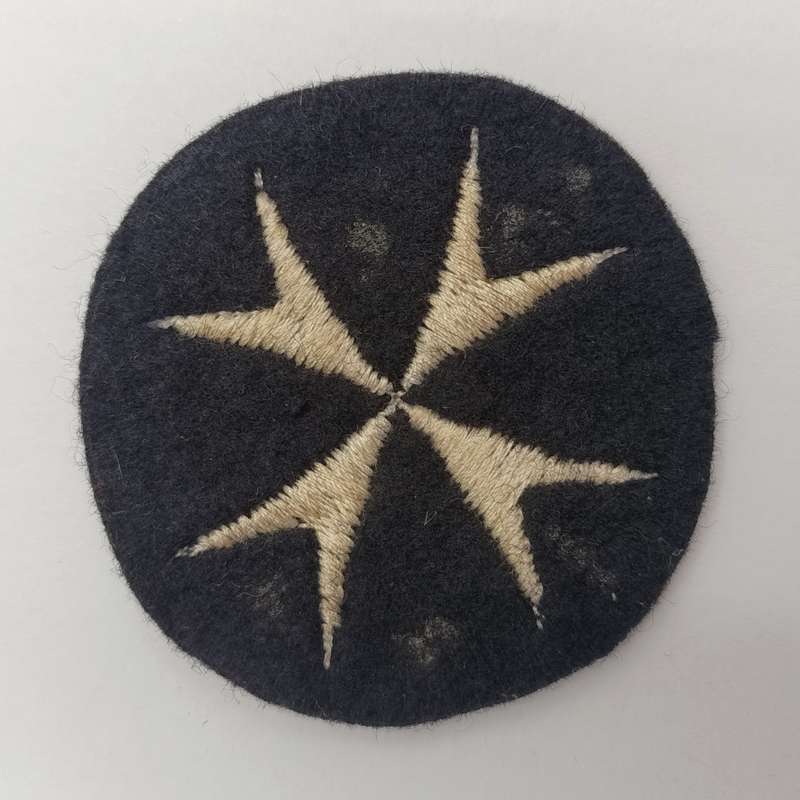 Collection of vintage St. John Ambulance badges and insignia