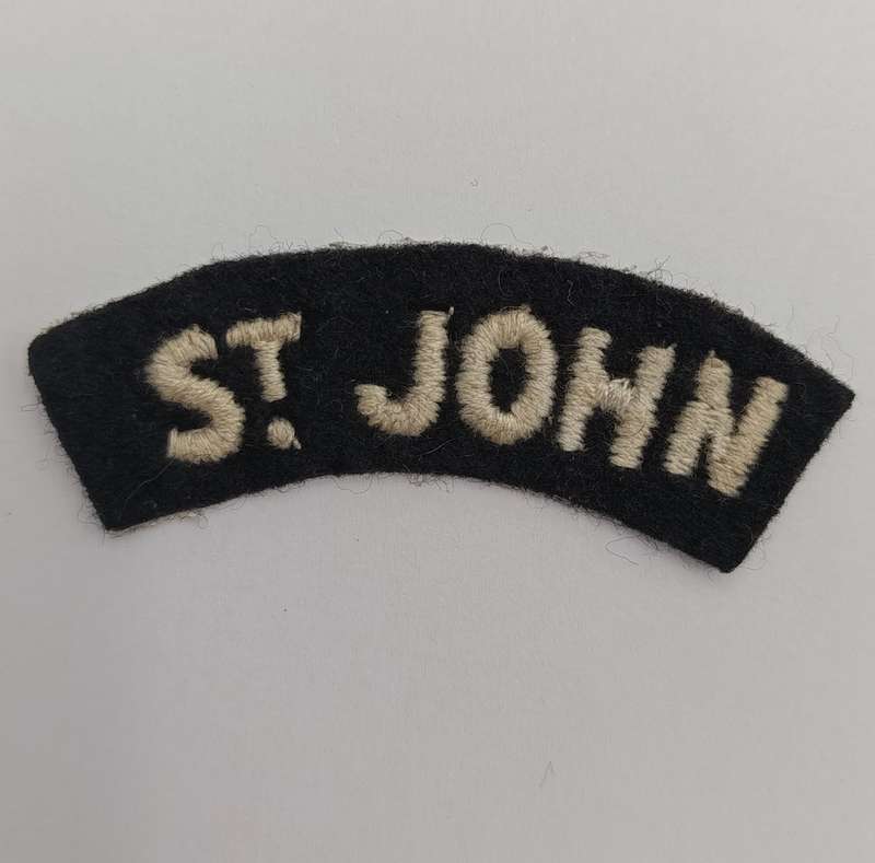 Collection of vintage St. John Ambulance badges and insignia