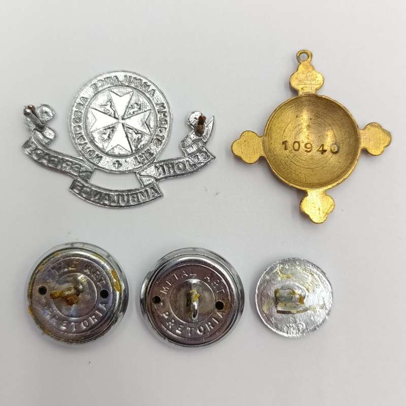 Collection of vintage St. John Ambulance badges and insignia
