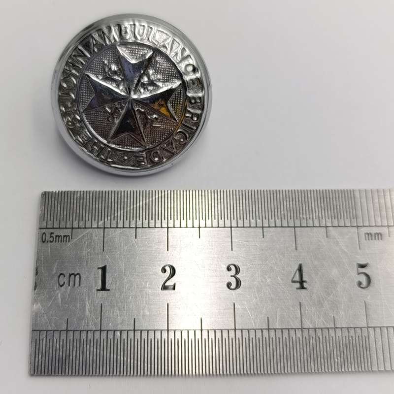 Collection of vintage St. John Ambulance badges and insignia
