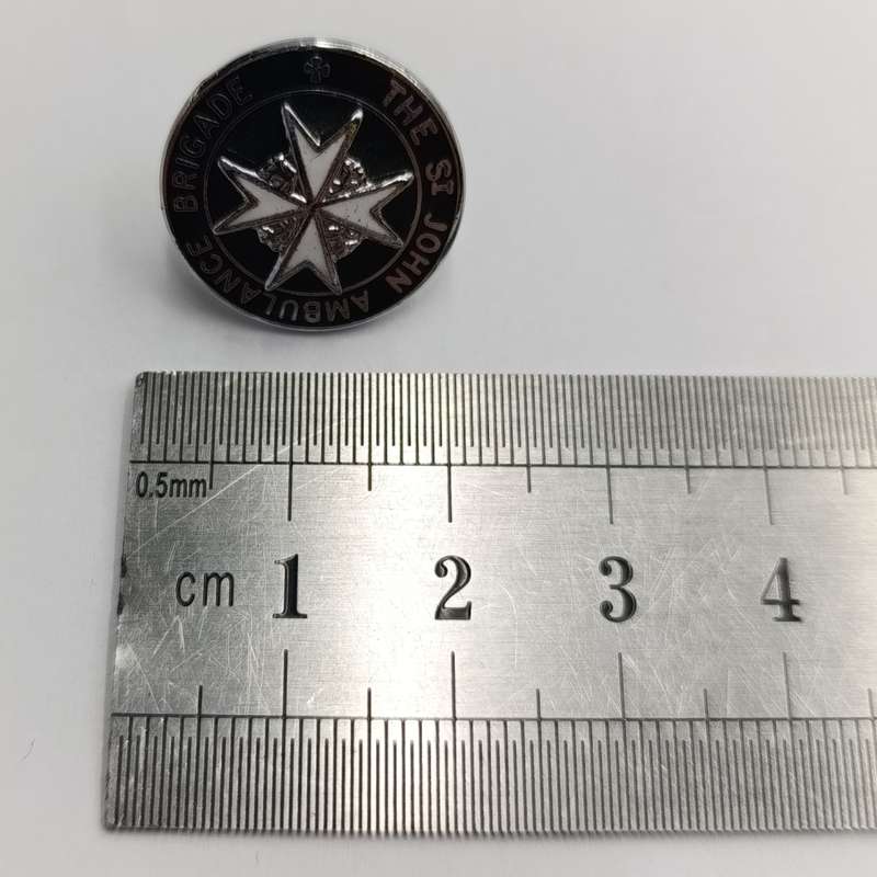Collection of vintage St. John Ambulance badges and insignia