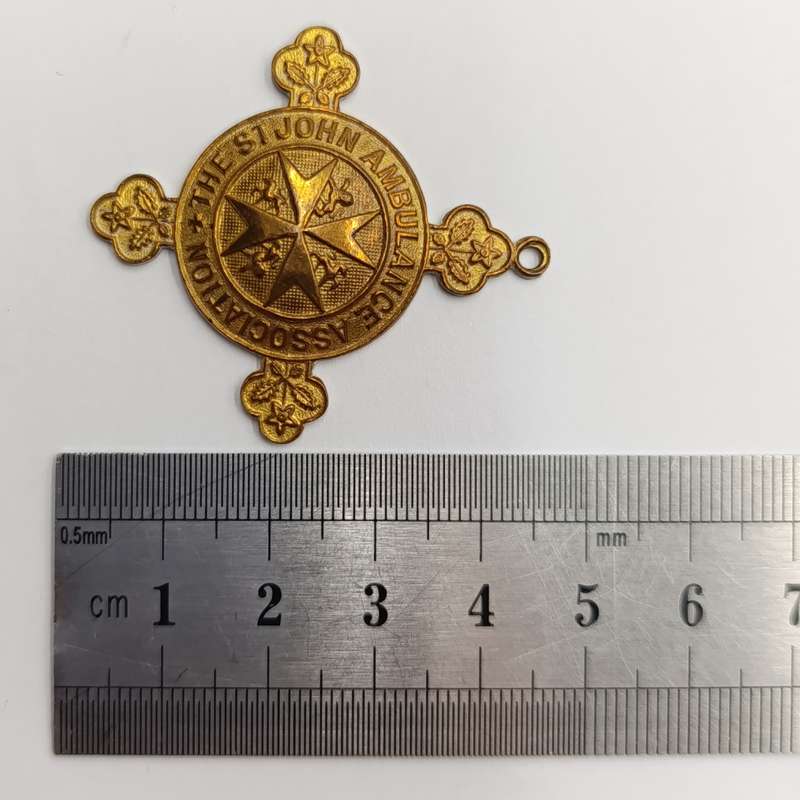 Collection of vintage St. John Ambulance badges and insignia