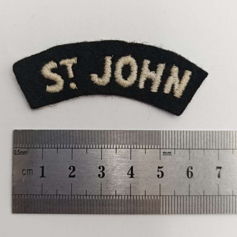 Collection of vintage St. John Ambulance badges and insignia
