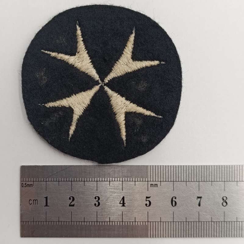 Collection of vintage St. John Ambulance badges and insignia