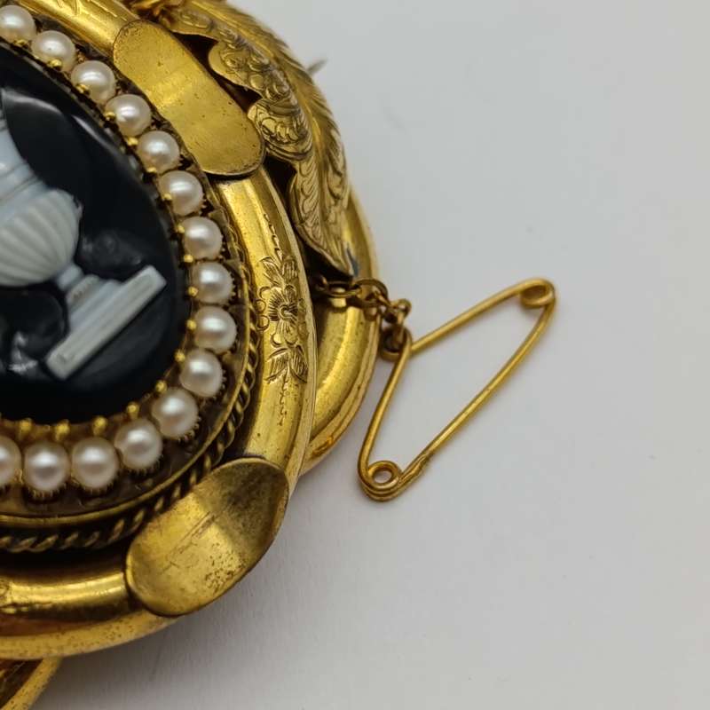Antique low grade gold  mourning brooch with hair locket on back and safety chain