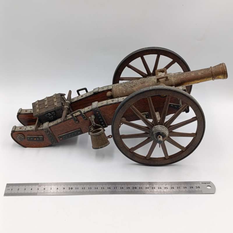 Vintage Napoleon toy cannon model with accessories