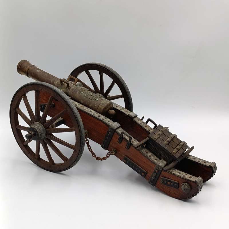 Vintage Napoleon toy cannon model with accessories