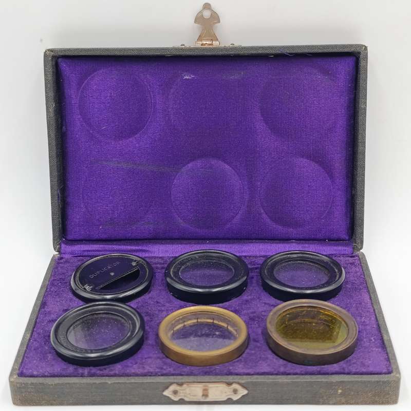 Antique camera lens filter set in case