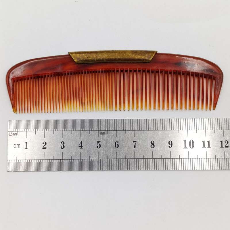 Antique pocket comb with brass case