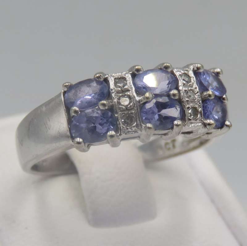 9kt white gold ring with 6 small diamonds and 6, iolites. Weight 3.5g , Size O
