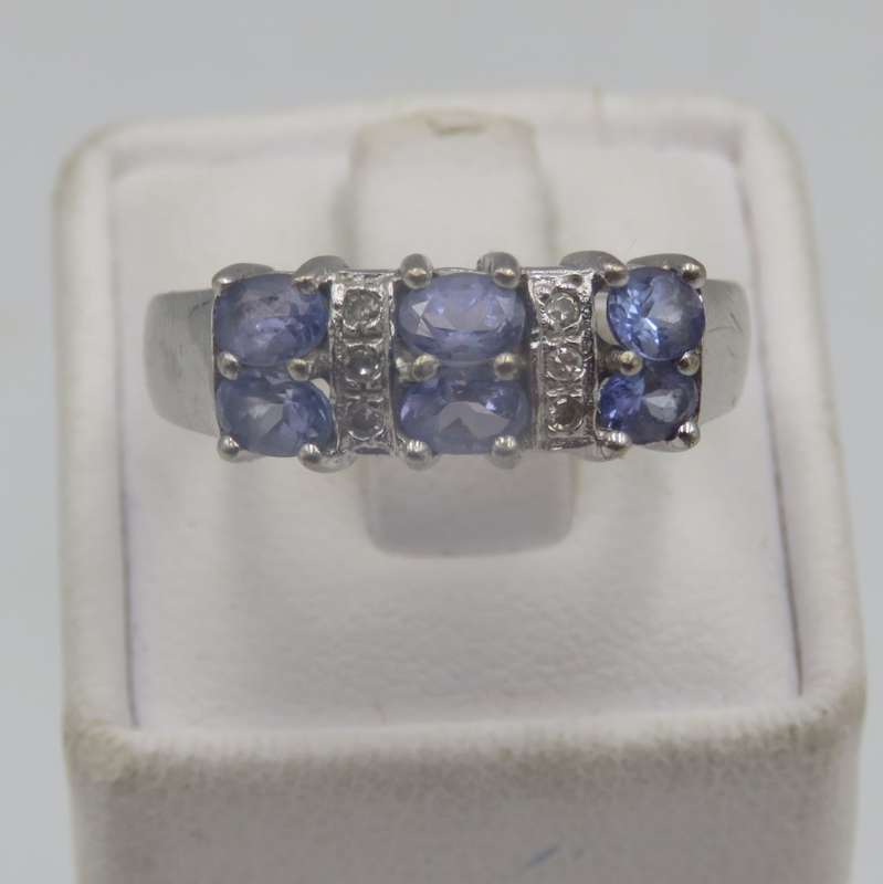 9kt white gold ring with 6 small diamonds and 6, iolites. Weight 3.5g , Size O