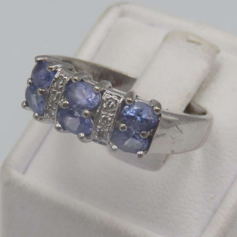9kt white gold ring with 6 small diamonds and 6, iolites. Weight 3.5g , Size O